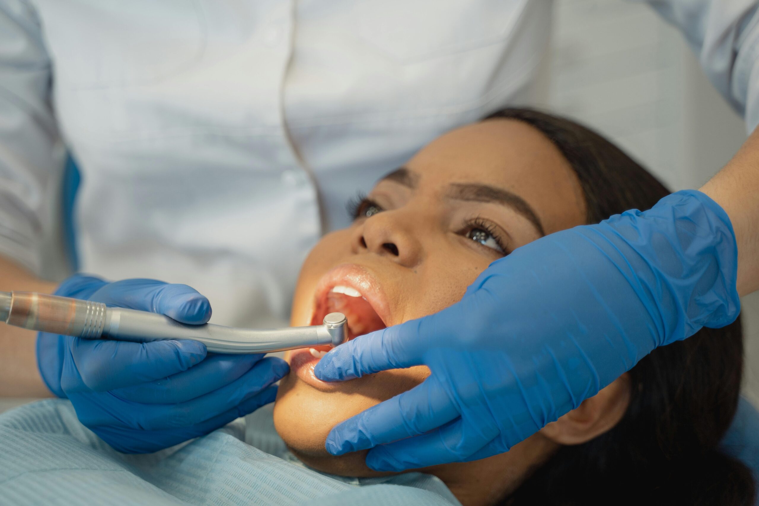 Close-up of a dentist performing a dental treatment on a patient.